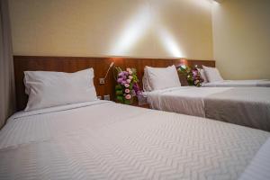 Ένα ή περισσότερα κρεβάτια σε δωμάτιο στο Emaar Elite Hotel