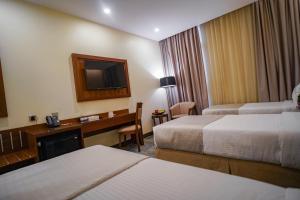 Ένα ή περισσότερα κρεβάτια σε δωμάτιο στο Emaar Elite Hotel