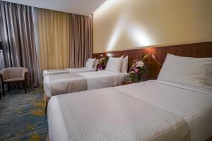 Ένα ή περισσότερα κρεβάτια σε δωμάτιο στο Emaar Elite Hotel