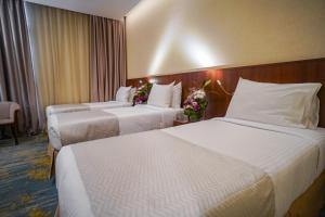 Ένα ή περισσότερα κρεβάτια σε δωμάτιο στο Emaar Elite Hotel