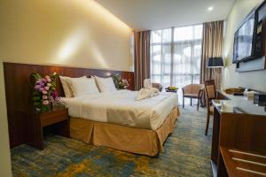 Ένα ή περισσότερα κρεβάτια σε δωμάτιο στο Emaar Elite Hotel