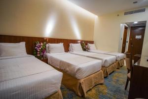 Ένα ή περισσότερα κρεβάτια σε δωμάτιο στο Emaar Elite Hotel