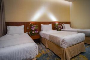Ένα ή περισσότερα κρεβάτια σε δωμάτιο στο Emaar Elite Hotel