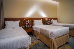 Ένα ή περισσότερα κρεβάτια σε δωμάτιο στο Emaar Elite Hotel