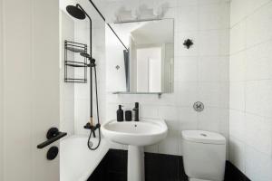 a bathroom with a sink and a toilet and a mirror at Urban Condo 11 - 1 Bdr in Nicosia +21 photos
