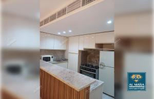 a kitchen with white cabinets and a counter top at للايجار ايام الصيف فيلا فاخره بستيلا هايتس - الساحل الشمالي in El Alamein