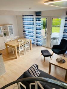 a living room with a table and a dining room at Ferienhaus Kiebitz in Dorum Neufeld