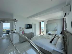 a bedroom with a bed and a bath tub at Donna Alba Seaview Penthouse, casa ta de pe plajă in Neptun +54 photos