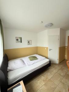 a bedroom with a bed in a room at Hotel Restaurant Neffelthal in Kerpen
