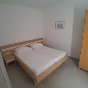 Postel nebo postele na pokoji v ubytování Apartments Jurjevic