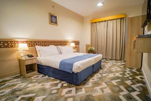 Voodi või voodid majutusasutuse Osturat Emaar Hotel toas