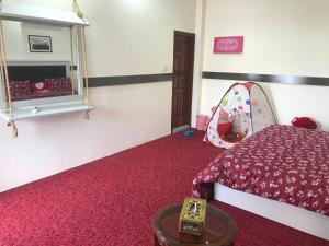a bedroom with a bed and a mirror and red carpet at Swat hilltop resort in Swat