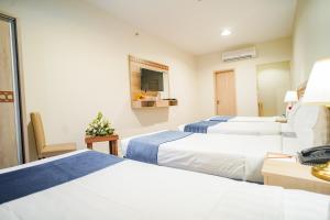 Voodi või voodid majutusasutuse Osturat Emaar Hotel toas