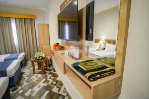 Voodi või voodid majutusasutuse Osturat Emaar Hotel toas