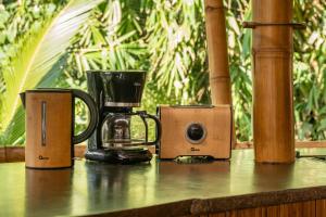 a coffee maker and speakers sitting on a table at Sunrise House 3bd Bamboo Villa Pool in Bringkit