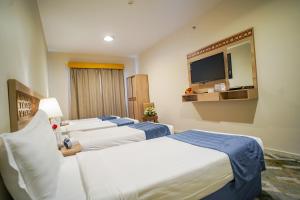 Voodi või voodid majutusasutuse Osturat Emaar Hotel toas