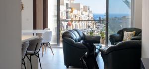 a room with two chairs and a table and a window at Mellieha, Charming 2 Bedroom Apartment Santa Maria Heights Mellieha in Mellieħa