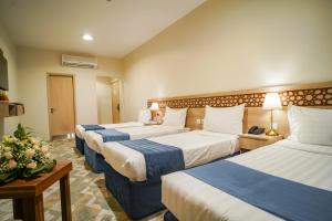 Voodi või voodid majutusasutuse Osturat Emaar Hotel toas