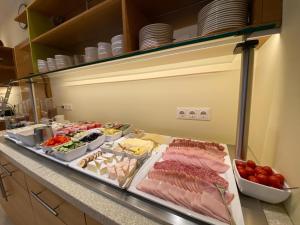 a kitchen counter with many different types of food at Hotel Leobersdorfer Hof in Leobersdorf