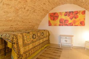 una camera da letto con un letto e un quadro sul muro di Dimora 51 a Putignano Altre 16 foto