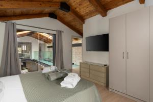 a bedroom with a bed with towels on it at The Olive Mill Loft - Oil Mill to Lavish Leisure in Prinés +23 photos