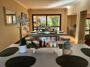 a living room with a table with wine bottles on it at Accommodation Bedfordview - Hethersett Guesthouse in Johannesburg