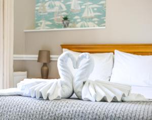 a swan made out of towels on a bed at The Wellington Hotel in Ventnor