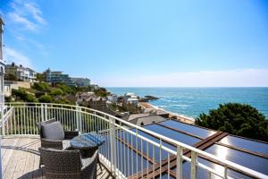 a balcony with chairs and a view of the ocean at The Wellington Hotel in Ventnor