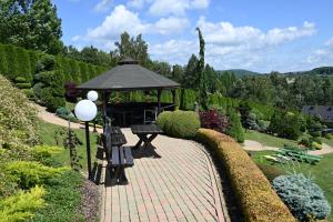 a park with a gazebo and benches in a garden at U Mateusza 607-737-859 in Polańczyk +9 photos