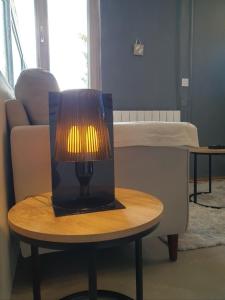 a lamp on a table next to a bed at I have a dream in Colmar +14 photos