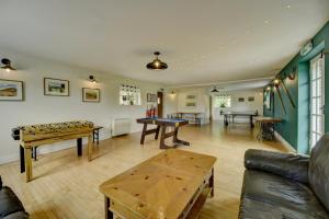 a living room with ping pong tables and a couch at Dunkery Cottage Wheddon Cross in Minehead