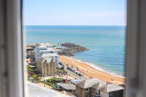 a view of a beach and buildings and the ocean at The Wellington Hotel in Ventnor