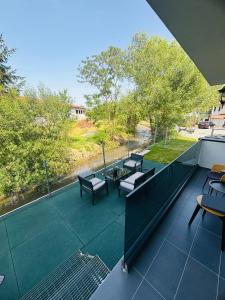 a view of a balcony with tables and chairs at Golden Apartament in Şelimbăr