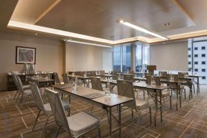 a dining room with tables and chairs and windows at Wyndham Grand Istanbul Levent in Istanbul