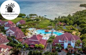 an image of the resort with the words vacation caribbean caribbean paradise at Couleur Caraïbes-TI EVASION appartement dan un village club 3 étoiles vue mer in Sainte-Luce