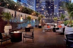 a rooftop patio with tables and chairs in a city at DoubleTree by Hilton Chicago Magnificent Mile in Chicago