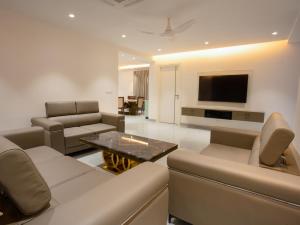a living room with a couch and a table at Let Home in Hyderabad