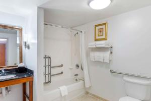 a bathroom with a toilet sink and a shower at Comfort Suites Longmont in Longmont