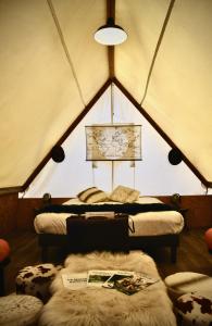 a room with two beds in a tent at Parc Du Coq à l'Âne - Lodges Insolites in Saint-Georges-de-Rex