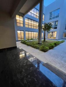 a building with a reflection in a pool of water at Luxury Smart Apartment E12 in Riyadh