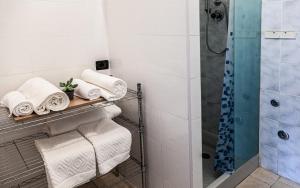 a bathroom with towels on a rack and a shower at Casa Galilei 5 minuti dal mare in San Salvo