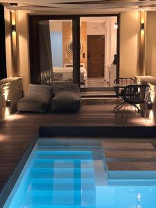 a swimming pool in the middle of a living room at Skopelos Holidays Hotel & Spa in Skopelos Town
