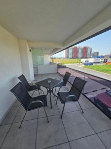 a patio with a table and chairs on a balcony at Hunyadi Luxury Evolution in Sibiu