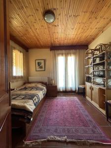 a bedroom with a bed and a wooden ceiling at Villa Maron - Platanitis Beach in Maronia