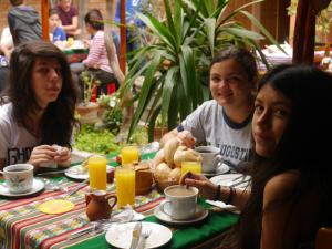 a group of people sitting at a table with food at Hostal Tambo Colorado in Pisco