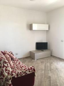 a living room with a bed and a television at Everything a bike ride away! 10 mins to the beach with free parking! in Marina di Grosseto