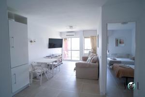 a white living room with a couch and a table at Minerva NeW in Benalmádena