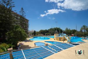 a large swimming pool with a slide at a resort at Minerva NeW in Benalmádena