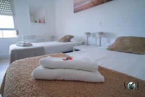 a room with two beds with towels on the bed at Minerva NeW in Benalmádena +18 photos