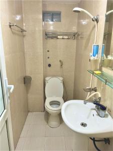 a bathroom with a toilet and a sink at Frontier Hostel & Tours in Dien Bien Phu +73 photos